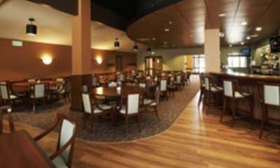 Dining area with tables and chairs in a well-lit room