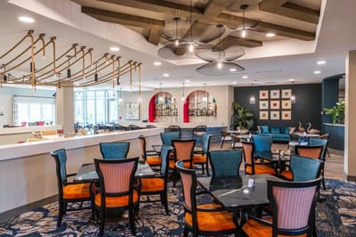 Bright and welcoming common area with dining tables