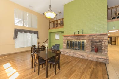 Spacious common area with a fireplace and dining table