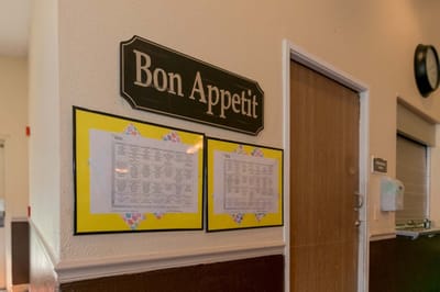 Dining room sign with menu postings in a facility