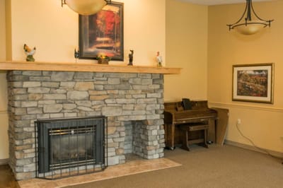 Interior view of a common area with a fireplace and piano