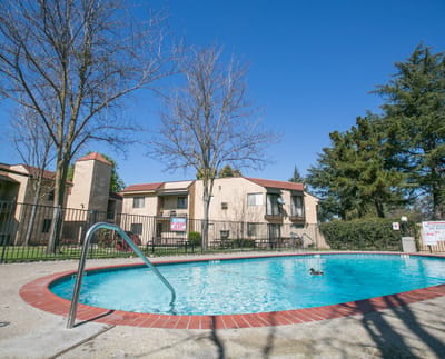 View of a swimming pool surrounded by housing units