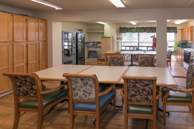 Bright common area with seating and kitchen access