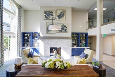 Bright common area with seating and floral arrangements