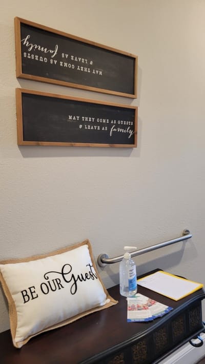 Decorative wall signs and a welcoming pillow in the lobby