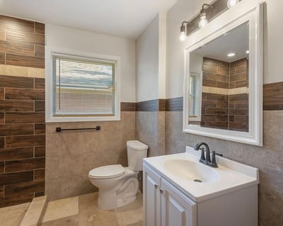 Well-lit bathroom with modern fixtures and tiles