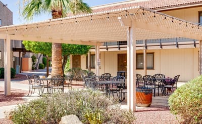 Outdoor seating area with tables and a pergola