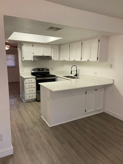 Modern kitchen with white cabinetry and countertops
