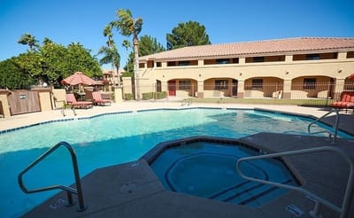 A serene pool area with lounge chairs
