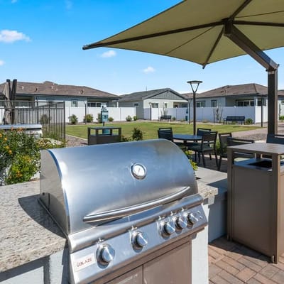 Outdoor grill area with seating and gardens