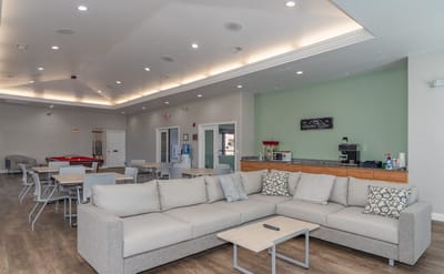 Bright common area with seating and game table