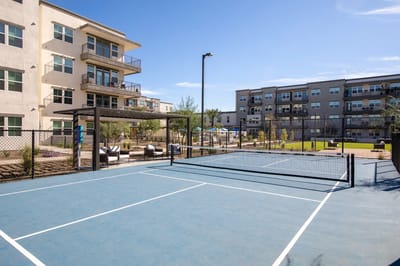 Outdoor recreational area with tennis court and buildings