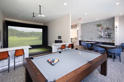 A bright and inviting activity lounge with a billiards table