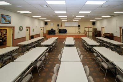Large multi-purpose common area with tables and chairs