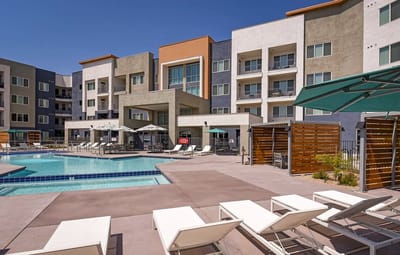 Outdoor pool area with lounge chairs and building exterior