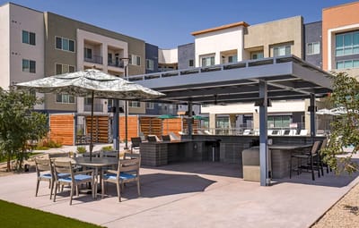Outdoor patio with seating and grill area