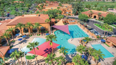 Aerial view of a large pool area with palm trees