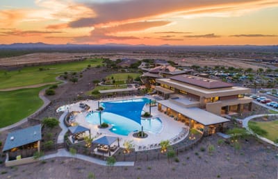 Aerial view of the facility with a pool at sunset