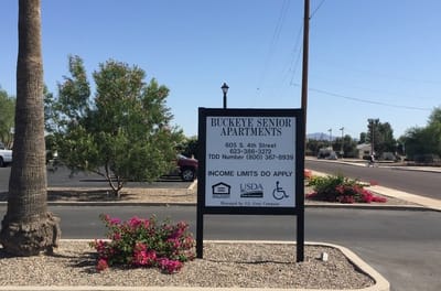 Sign for Buckeye Senior Apartments in a landscaped area