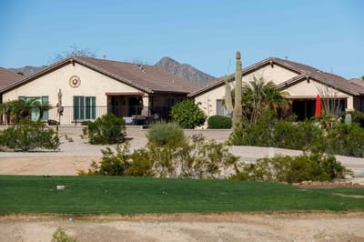 Exterior view of assisted living facility surrounded by desert landscaping