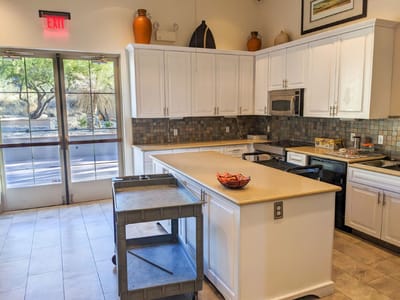 Bright kitchen area with modern appliances and seating