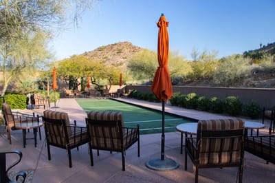 Outdoor seating area with mountain view and umbrellas