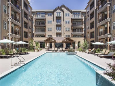 Outdoor view of a swimming pool with building behind