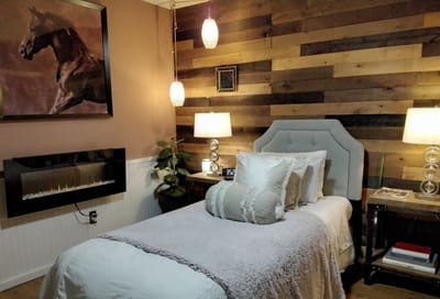 Cozy bedroom with warm lighting and wooden wall