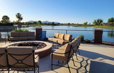 Outdoor seating area by the lake with mountain backdrop