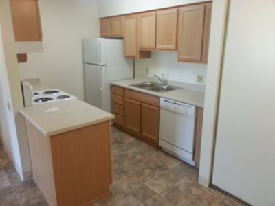 Kitchen area with appliances and cabinetry