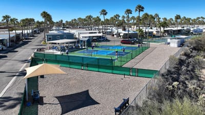 Aerial view of tennis courts surrounded by RVs