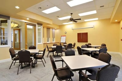 Bright and spacious common area with tables and chairs