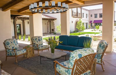 An inviting outdoor lounge area with seating and greenery