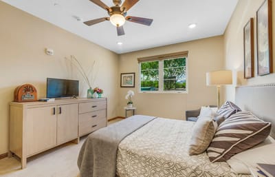 A cozy resident room with a bed and a view