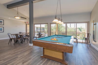 Interior of a common area with a pool table and seating