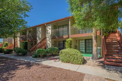 Exterior view of The Lakes Apartments with greenery