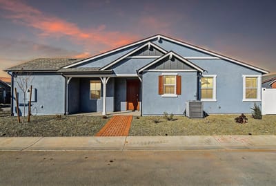 Exterior view of a blue multi-unit building with a path