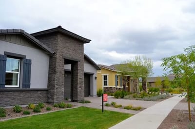 Exterior view of a senior living facility with gardens