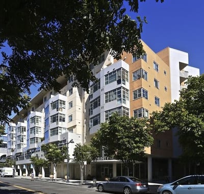 Exterior view of a senior living facility with trees