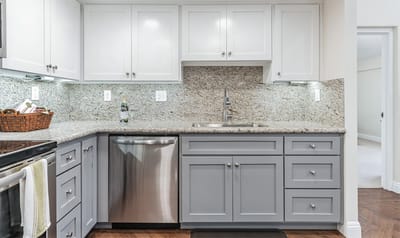 Modern kitchen interior with gray cabinets and granite countertops