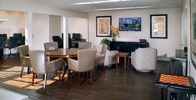 Bright common area with seating and a TV