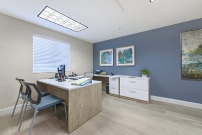 Brightly lit office space with furniture and art
