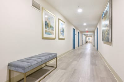 Well-lit hallway with artwork and seating