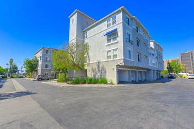 Exterior view of The Grove Senior Apartments with clear skies