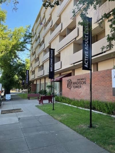 Exterior view of Madison Tower with welcoming signs