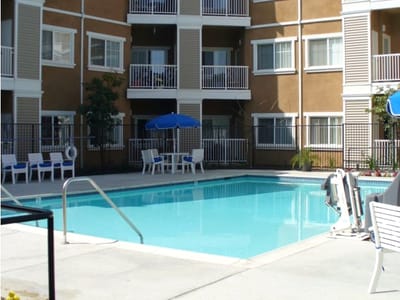 Outdoor pool area with lounge chairs and umbrellas
