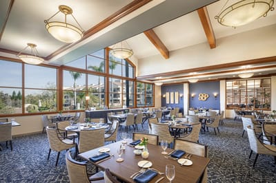Bright dining area with large windows and elegant decor