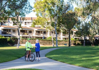 Two residents enjoying a walk in a garden area.