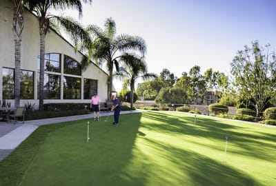 Residents enjoying golfing on a sunny day outside