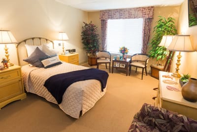 Cozy resident room with comfortable furnishings and plants